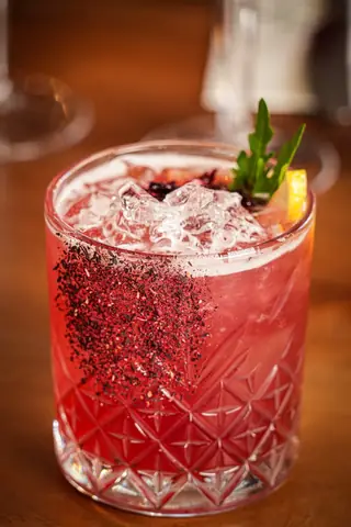 A red berry cocktail with crushed ice