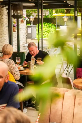 Guests dining among plants on the terrace