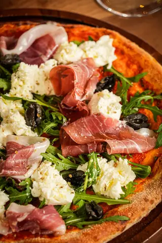 Close-up of a Parma ham and rocket pizza