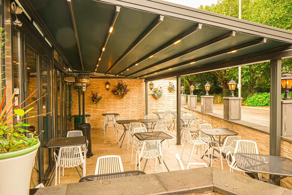 Al Dente’s covered terrace, with white chairs, hanging baskets and patio heaters